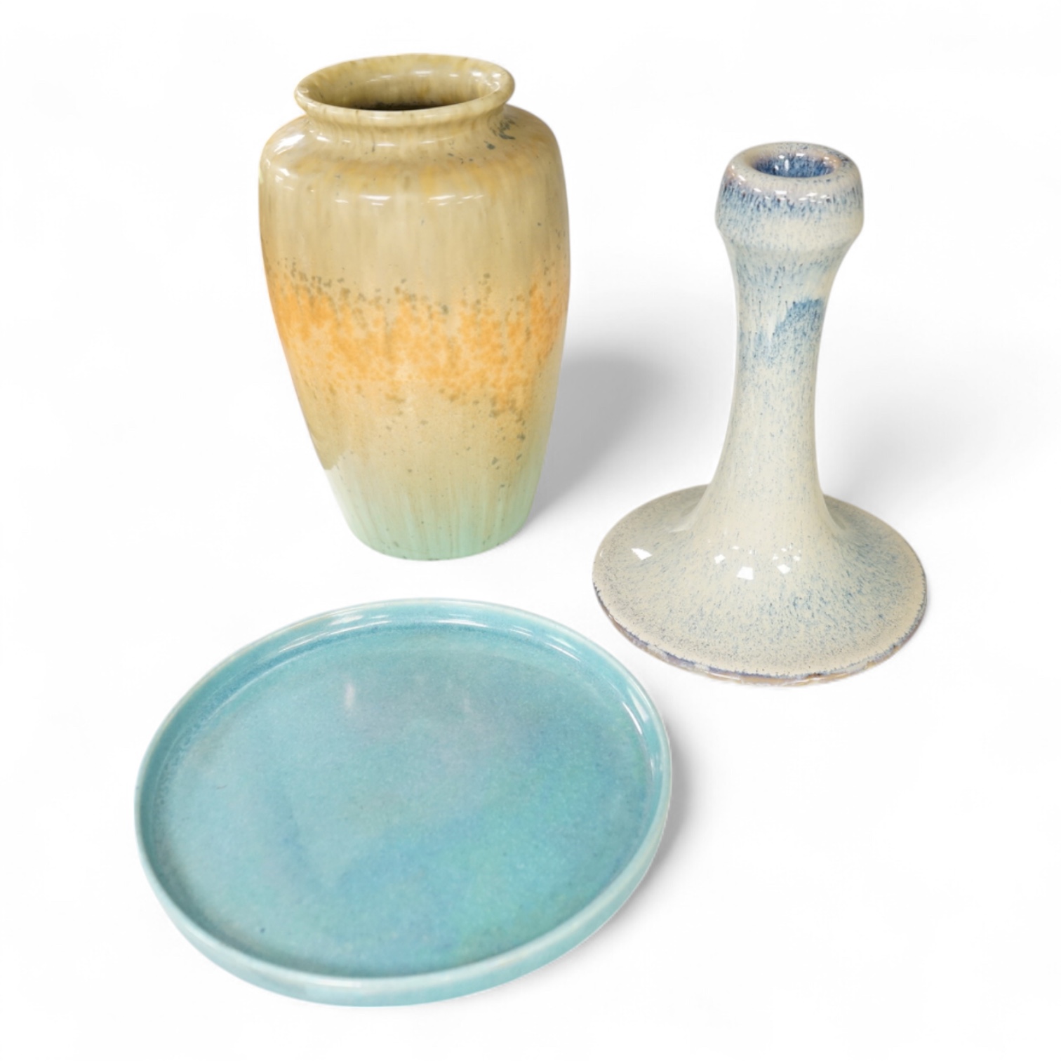 A Ruskin souffle glazed vase, impressed 1932, a Ruskin circular dish and an earthenware candlestick, tallest 21cm (3)